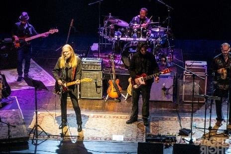 Gregg Allman playing guitar and singing