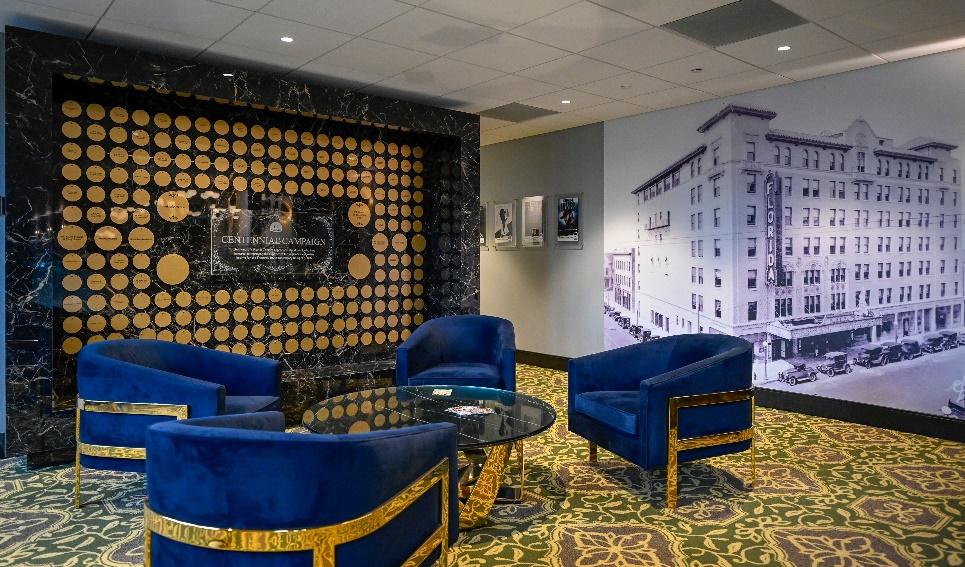 A room with blue chairs and a table