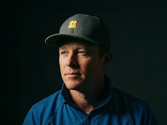 Portrait of a Peerstar peer specialist wearing a blue jacket and baseball cap
