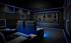 a blue and black private home cinema with Krix speakers