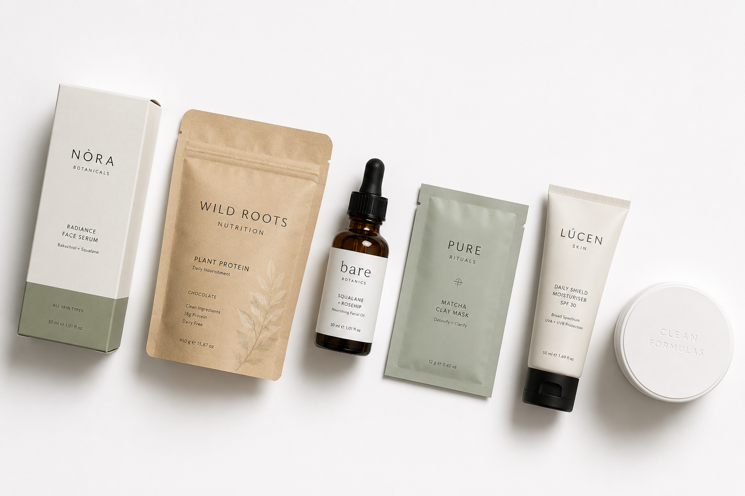 A flat lay of various minimal cosmetics and health products arranged neatly on a clean white surface. The collection highlights diverse packaging styles for D2C brand companies, including a brown paper pouch, glass dropper bottle, squeeze tubes, and cardboard boxes in muted earth tones.