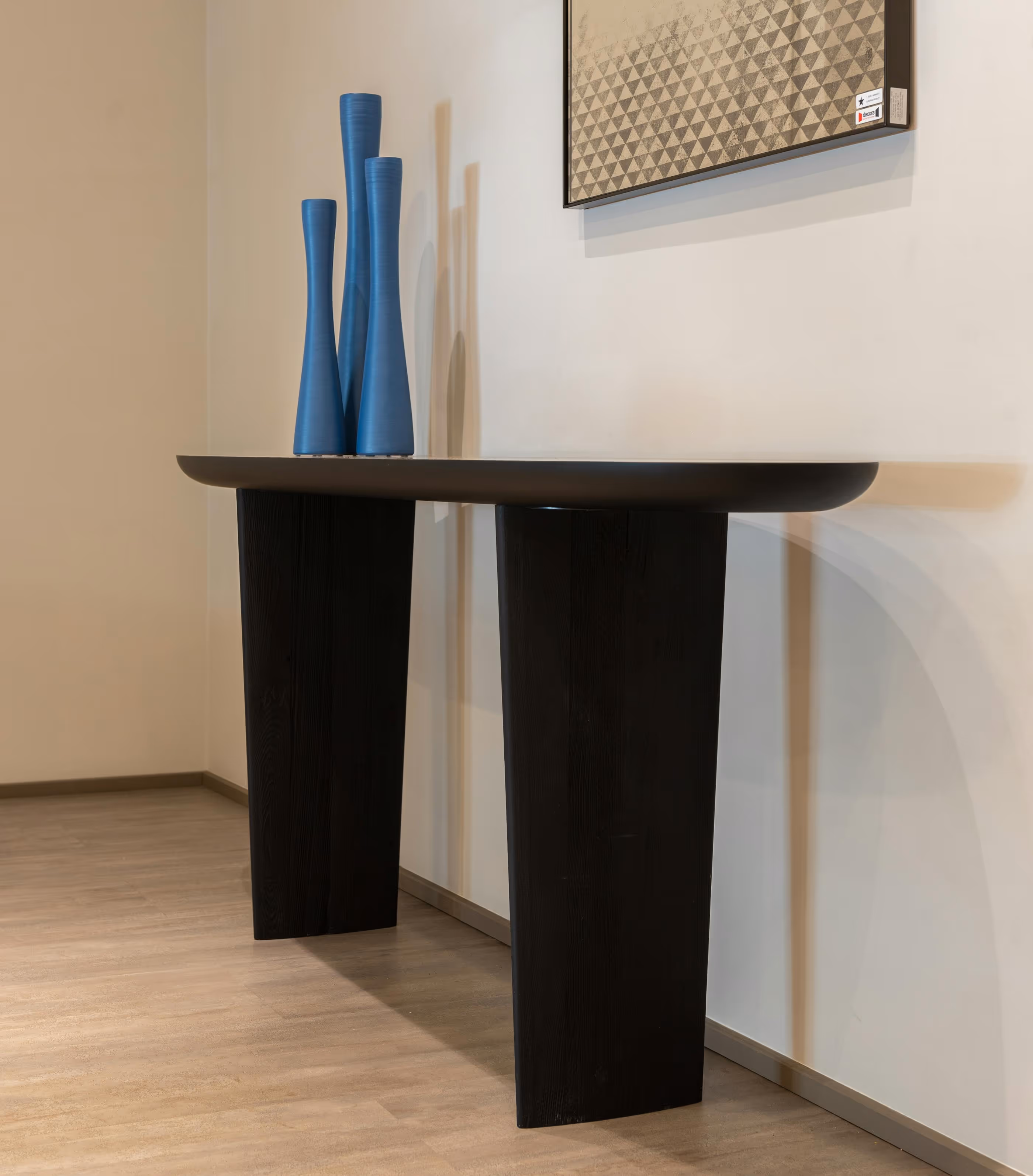 Dark wood console table with tall blue vases