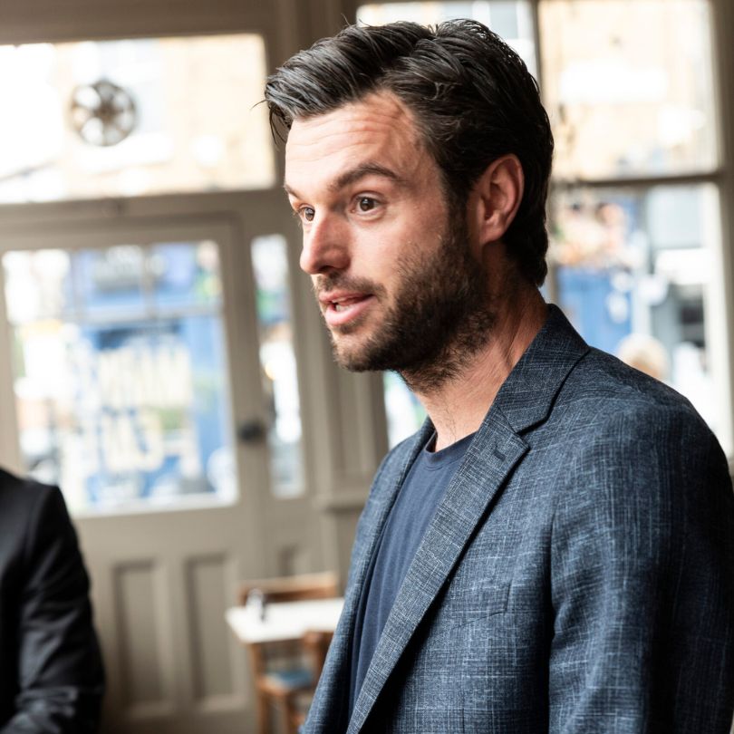 Portrait pleased attractive smiling female dressed fashionable denim jacket sees something appealing shop isolated