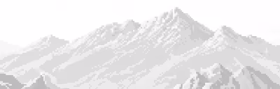 Black and white image of a mountain range with snow-covered peaks under a clear sky.