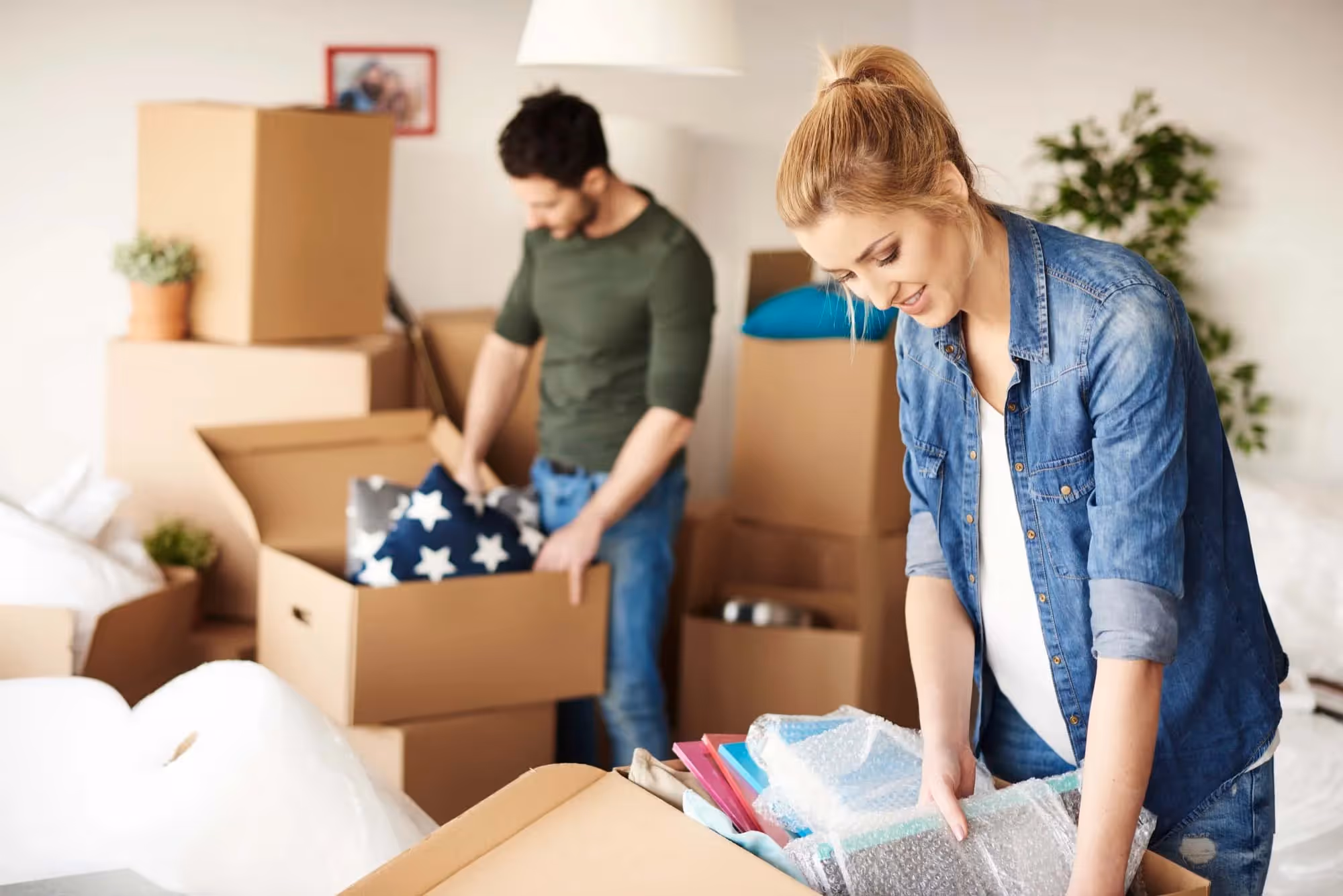 A couple filling boxes during a house move