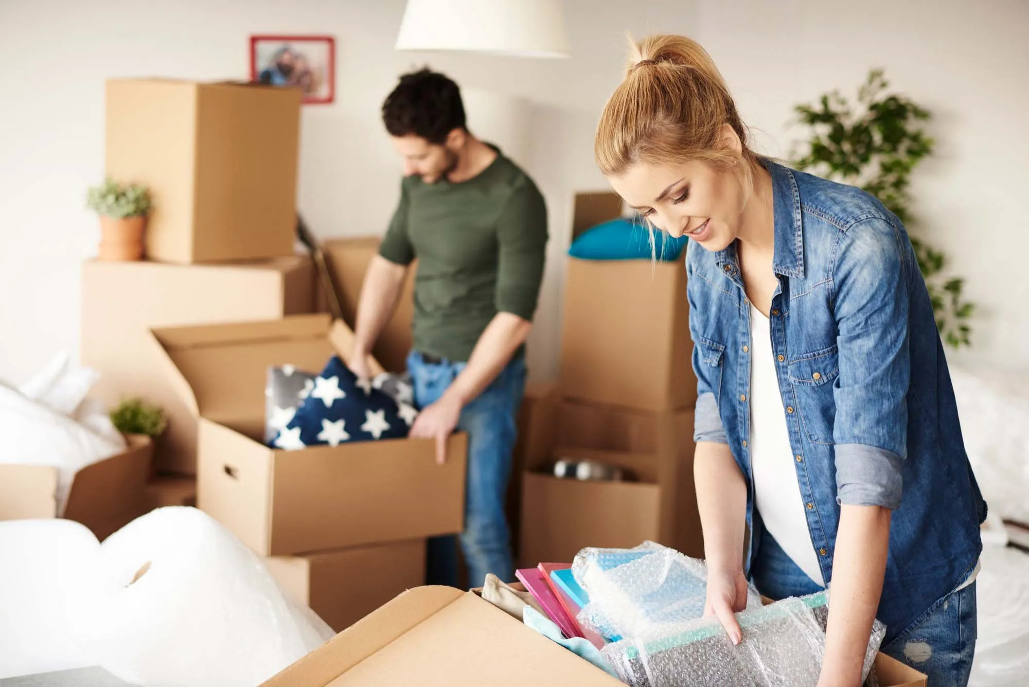 A couple filling boxes during a house move
