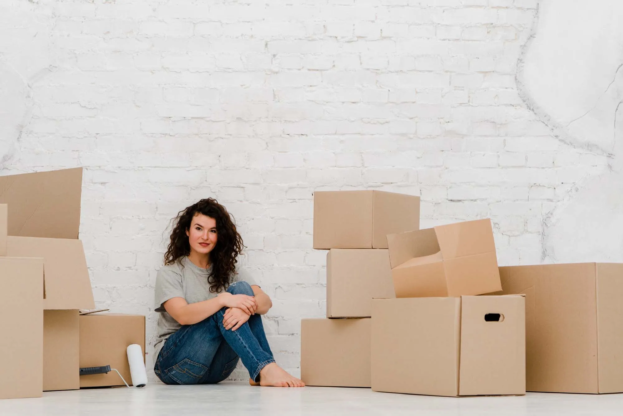 A woman surrounded by boxes during a house move