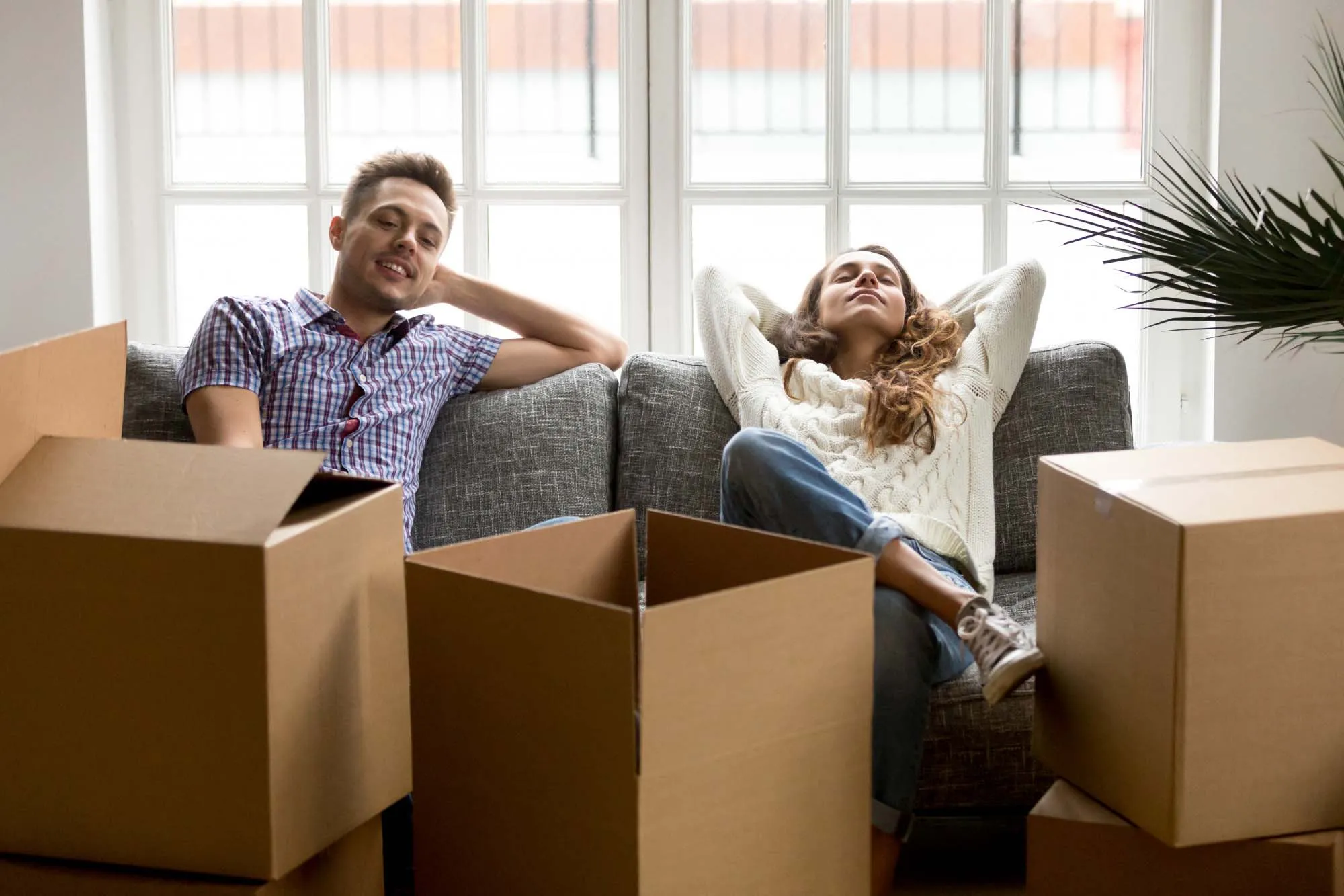 A couple surrounded by boxes during a house move