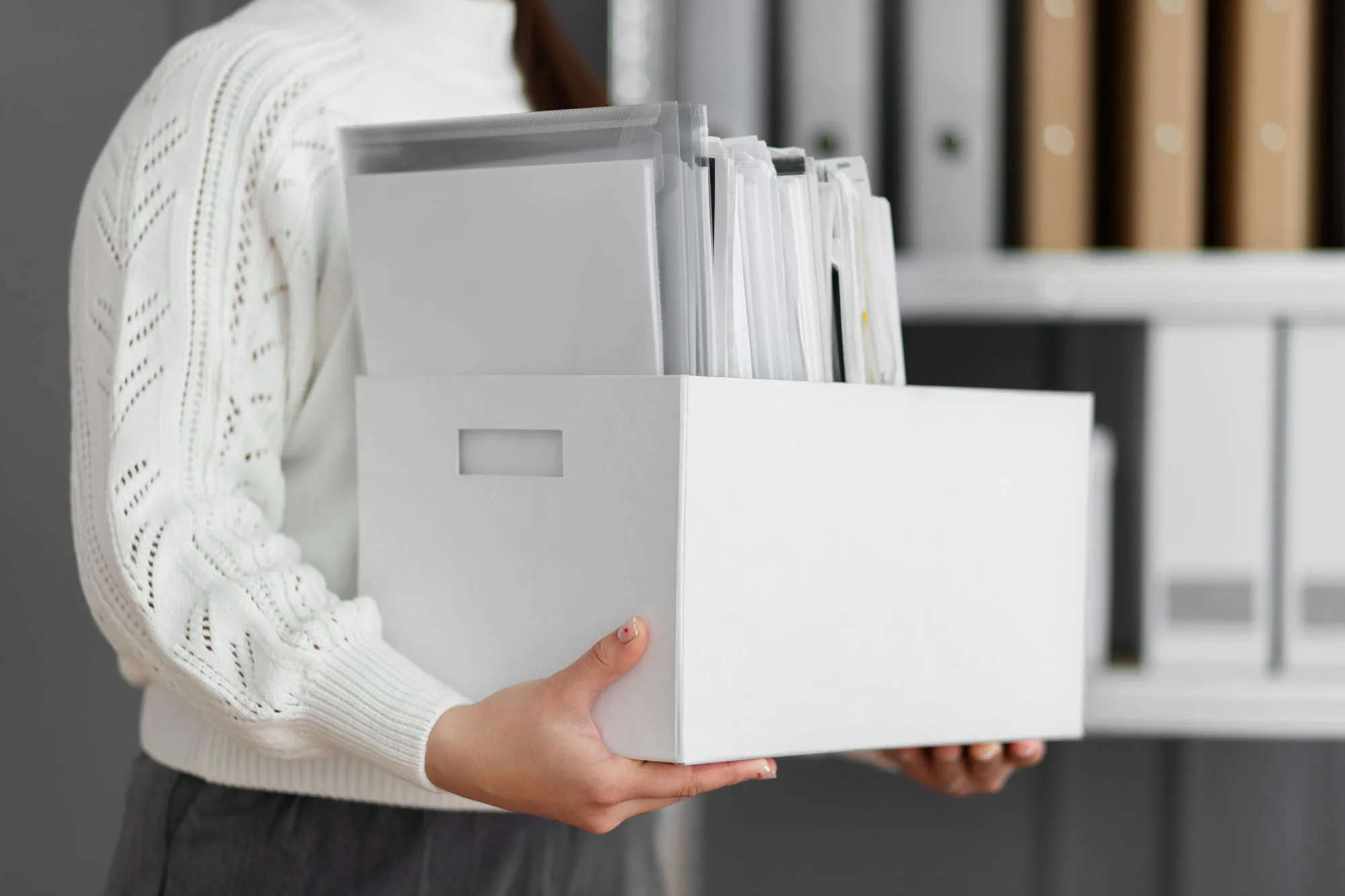 A man carrying a box of business documents