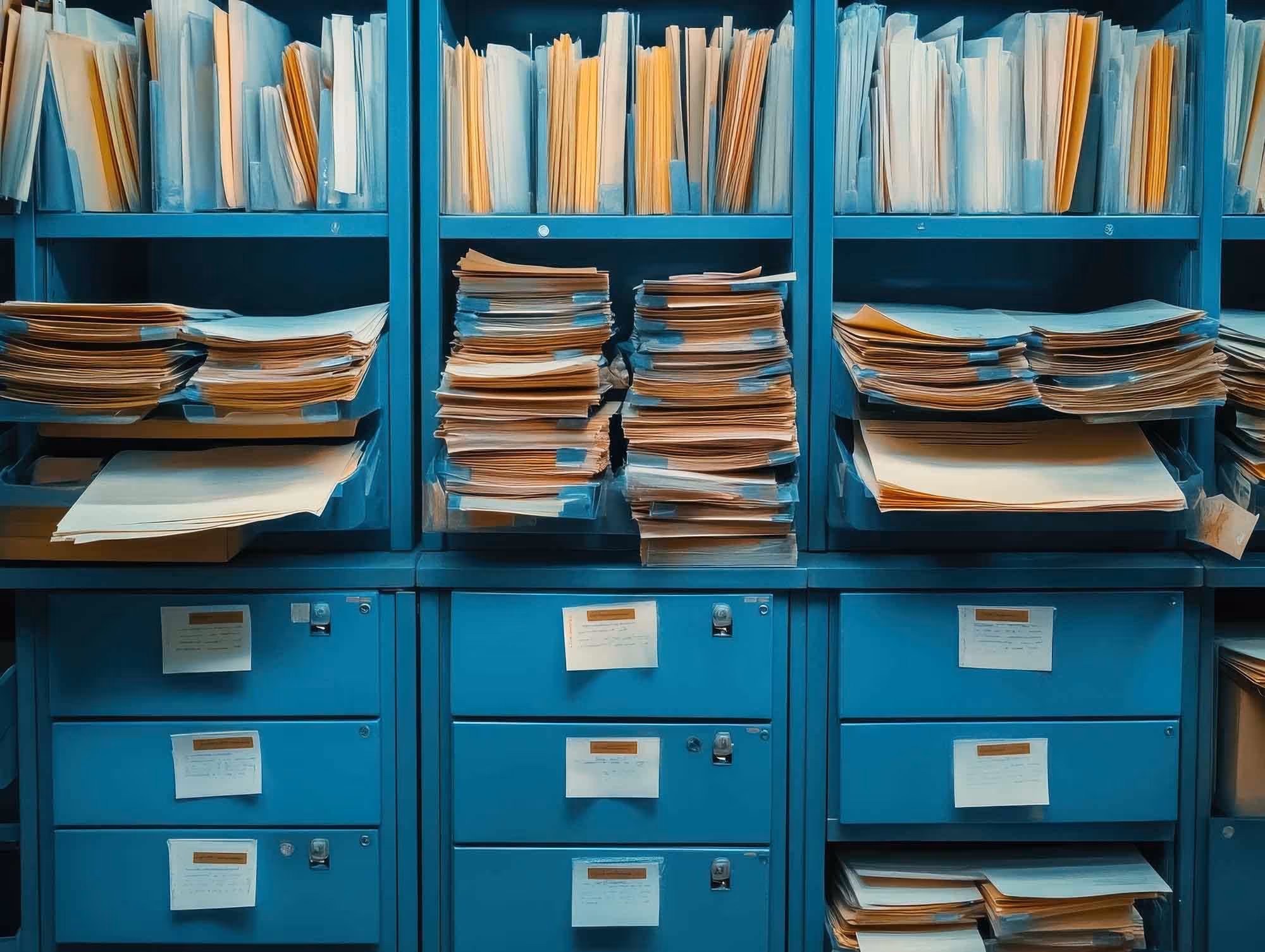 Business documentation stacked on shelving