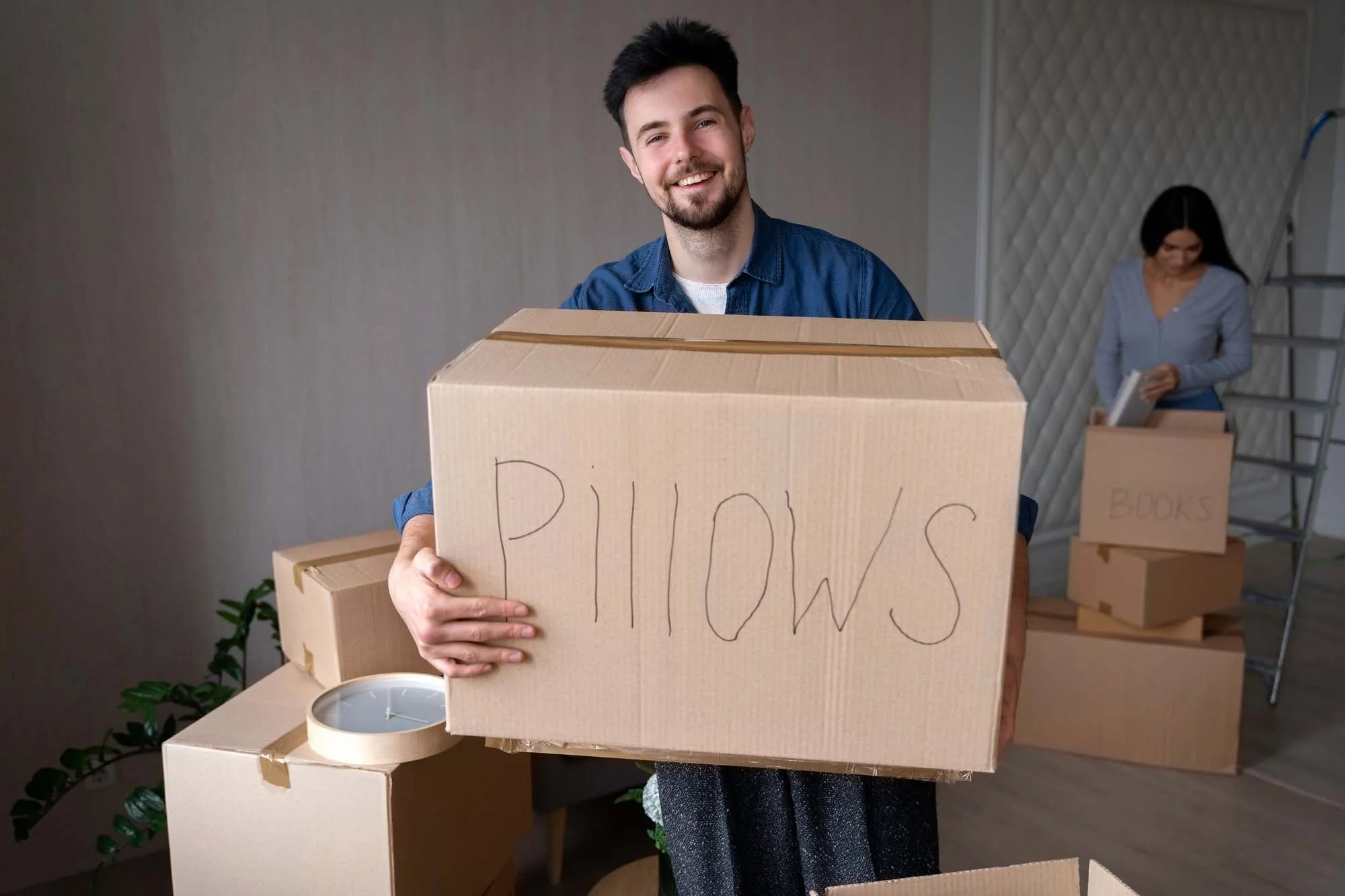 A man holding a storage box during a house move
