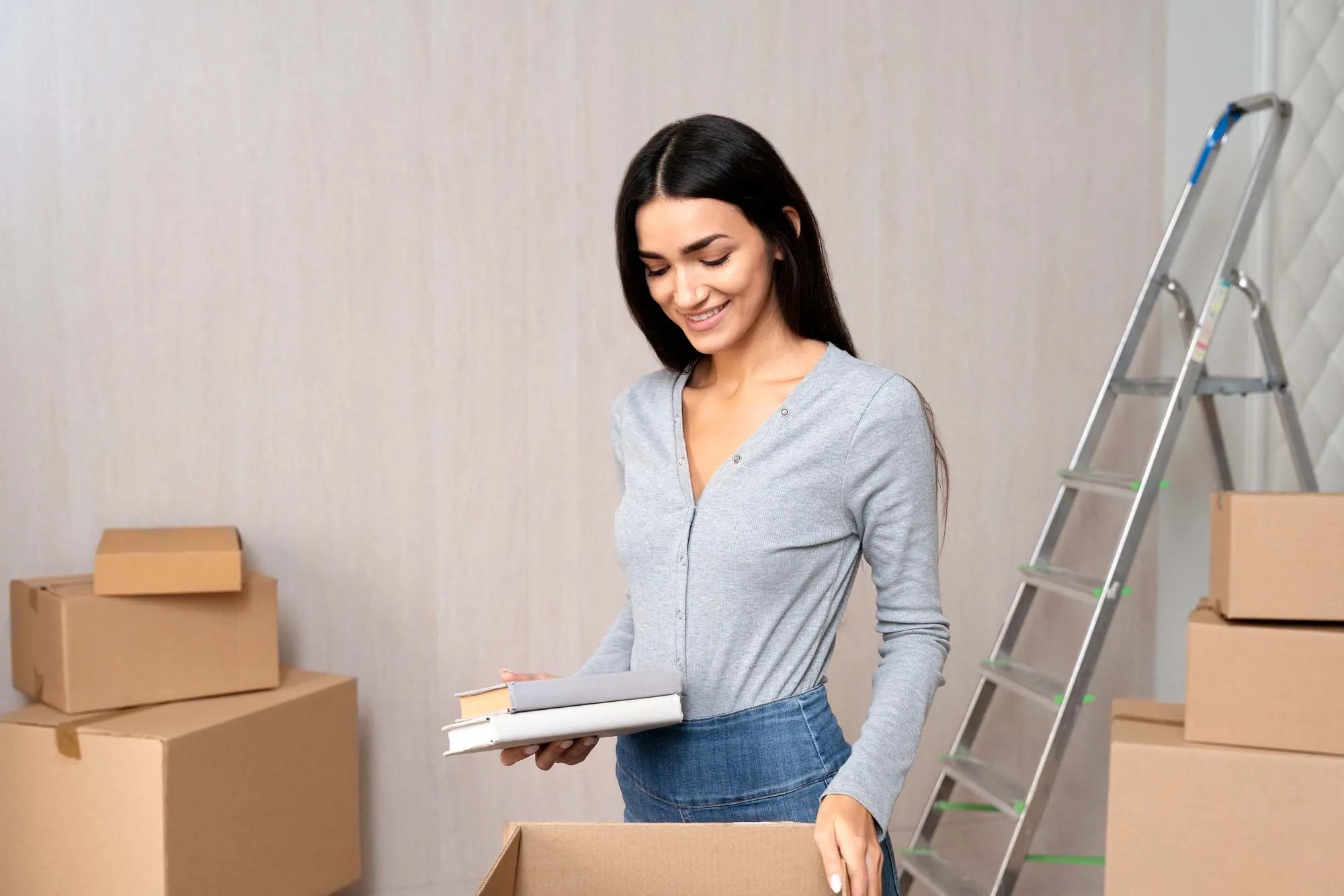 A woman surrounded by boxes during a house move