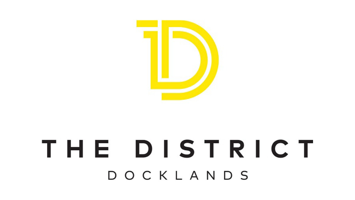 Yellow stylized 'D' logo above the text 'THE DISTRICT' and 'DOCKLANDS' in black letters.