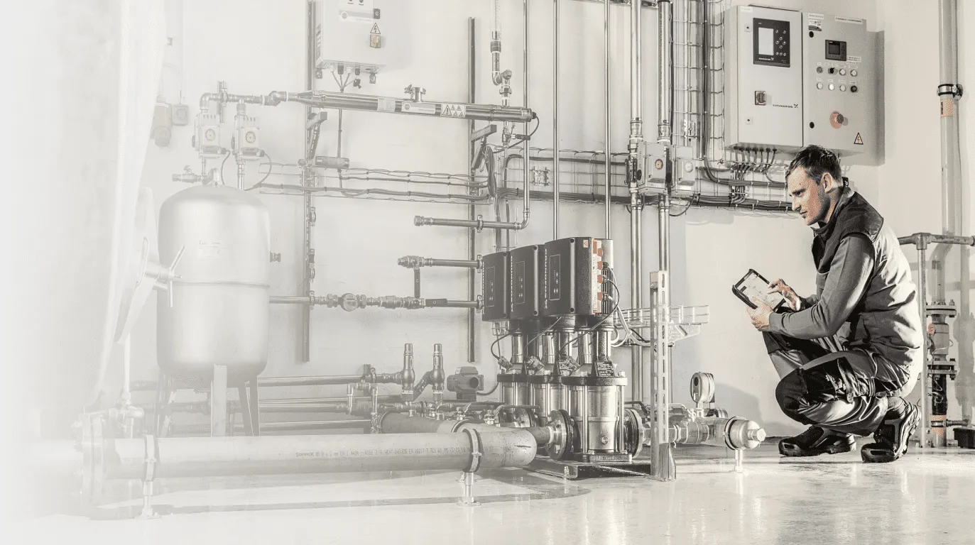 A technician in a factory looking at a tablet
