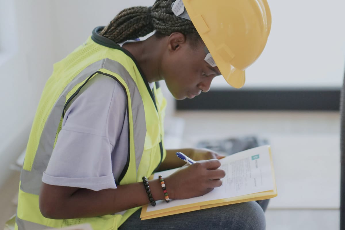 A technician making some notes about a work order
