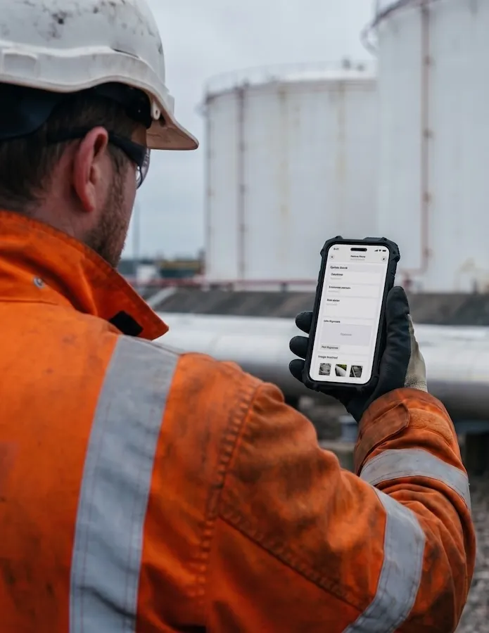 A technician looking at Arkyn FastForms at a gas plant