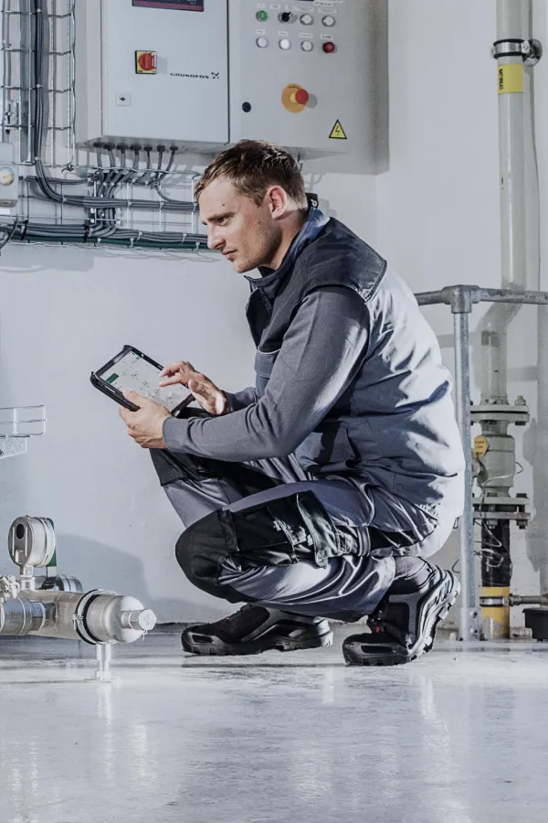 A technician inspecting equipment with Arkyn's FastForms app