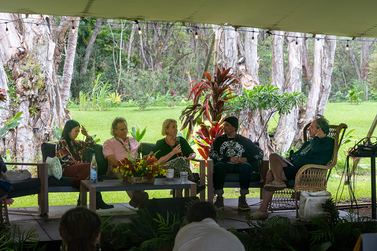 Traveler reaching out over the ocean, water streaming from their hand