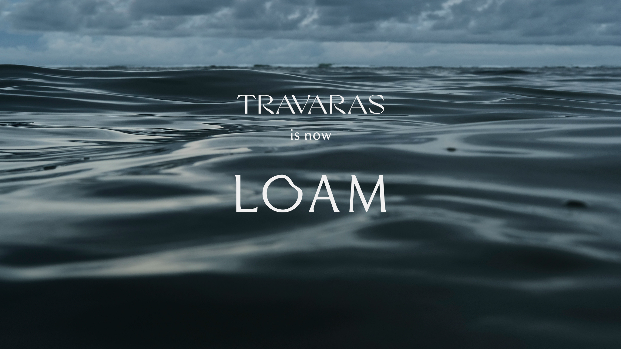 Traveler reaching out over the ocean, water streaming from their hand