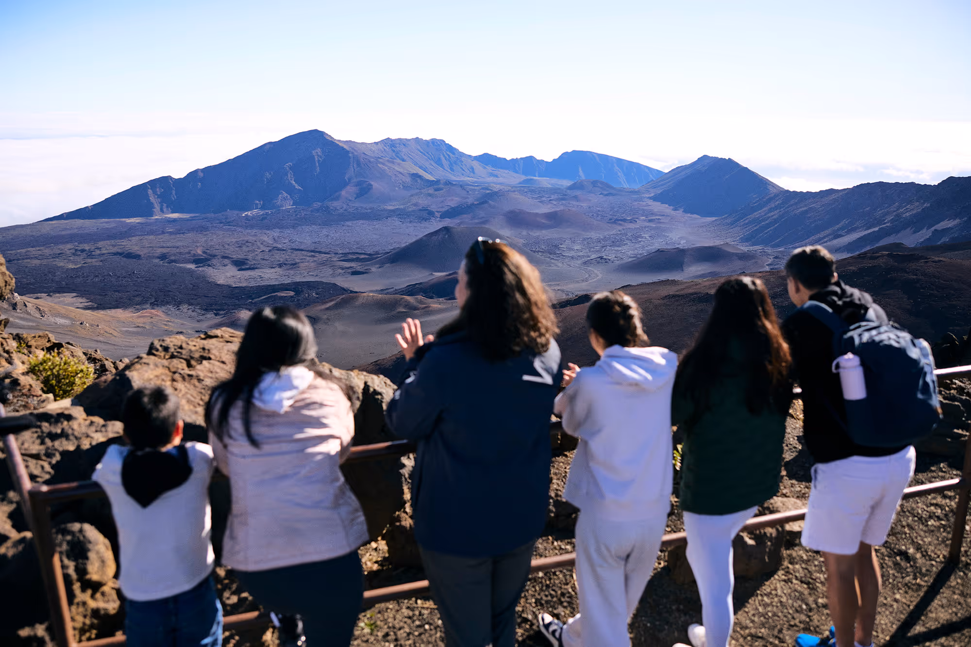 Traveler reaching out over the ocean, water streaming from their hand