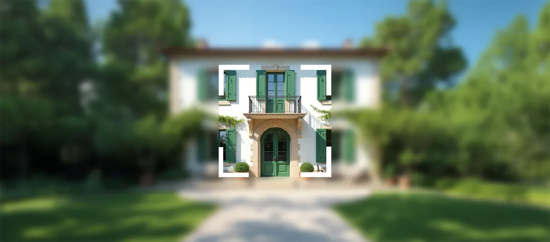 Focus on green-shuttered white house entrance with arched door, small balcony, and two potted bushes.