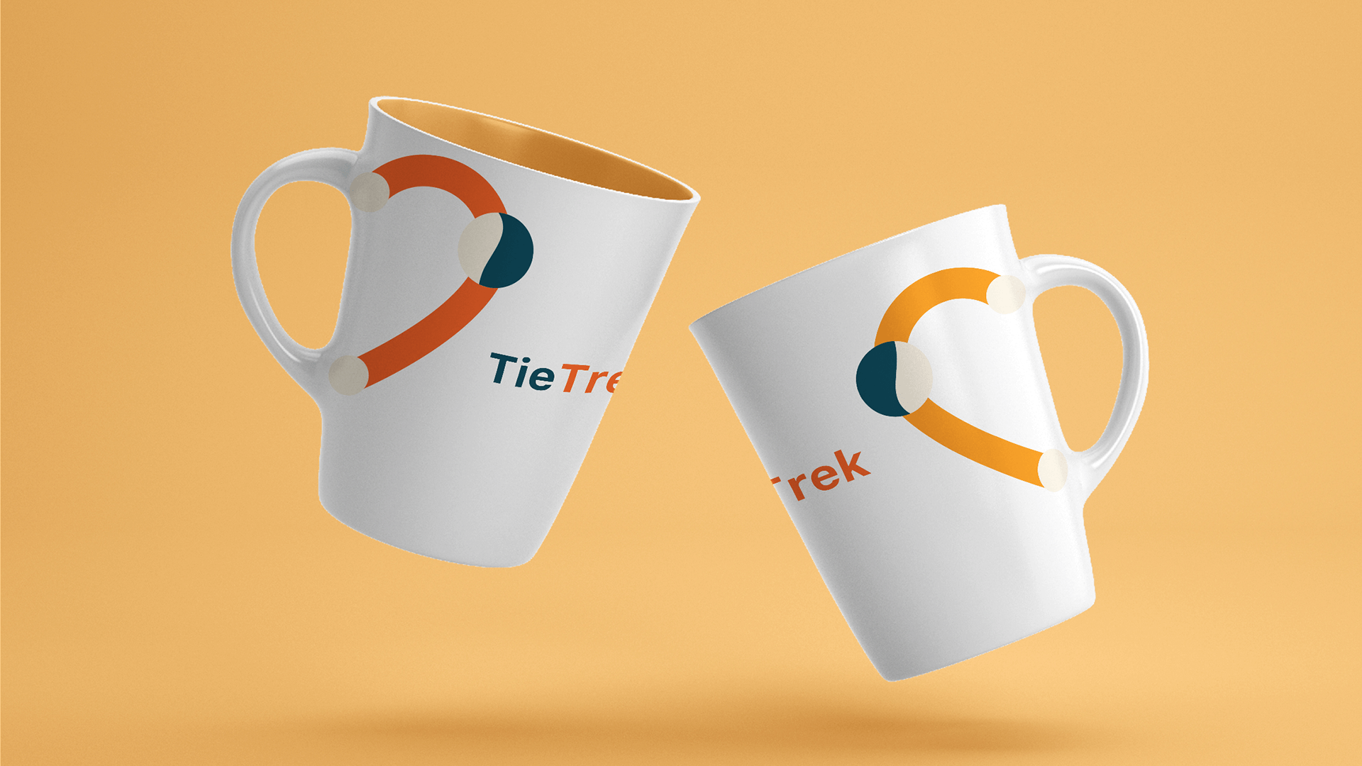 Two white TieTrek mugs with orange and teal logo graphics