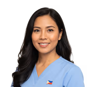 Smiling woman with long dark hair wearing a light blue scrub top with a Philippine flag pin.