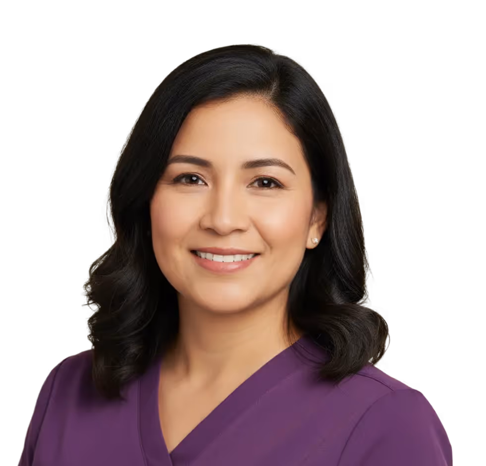 Smiling woman with shoulder-length black hair wearing a purple V-neck top.