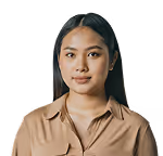 Portrait of a young woman with long dark hair wearing a beige collared shirt against a transparent background.