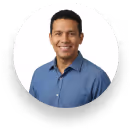 Smiling woman with long black hair wearing a red sleeveless top against a white background.