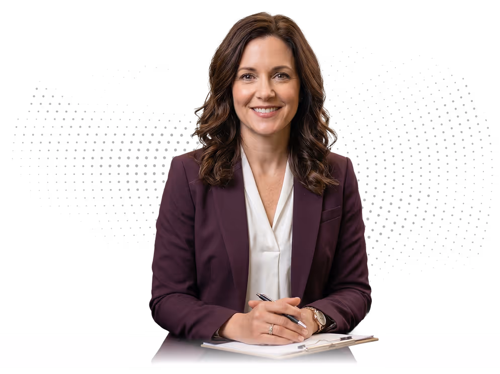 Smiling woman with brown curly hair in a purple blazer holding a pen over a clipboard.