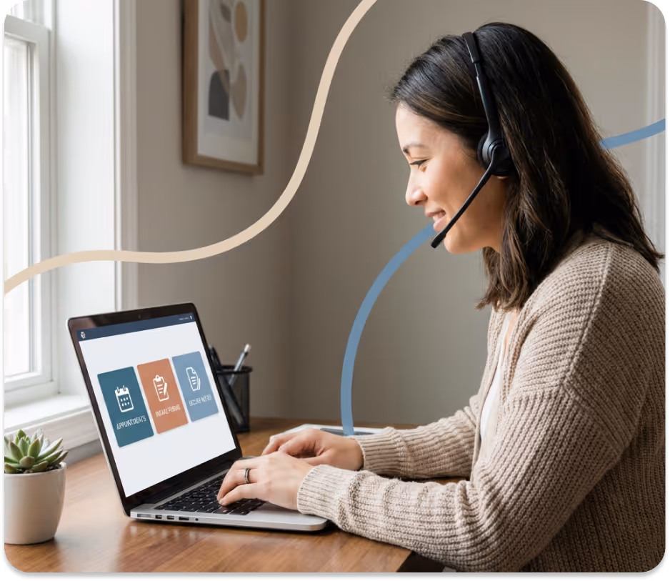 Woman wearing a headset smiling while typing on a laptop showing appointment, intake form, and secure notes icons.