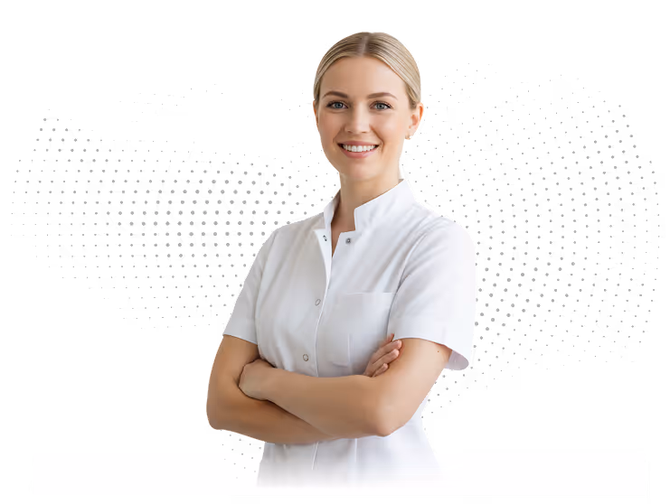 Smiling female healthcare professional in white coat with arms crossed standing.