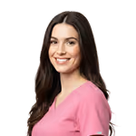 Smiling woman with long dark hair wearing a pink scrub top.