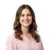Smiling woman with shoulder-length brown hair wearing a light pink blouse.