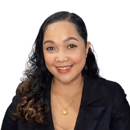 Smiling woman with curly hair wearing a black blazer and gold necklace.