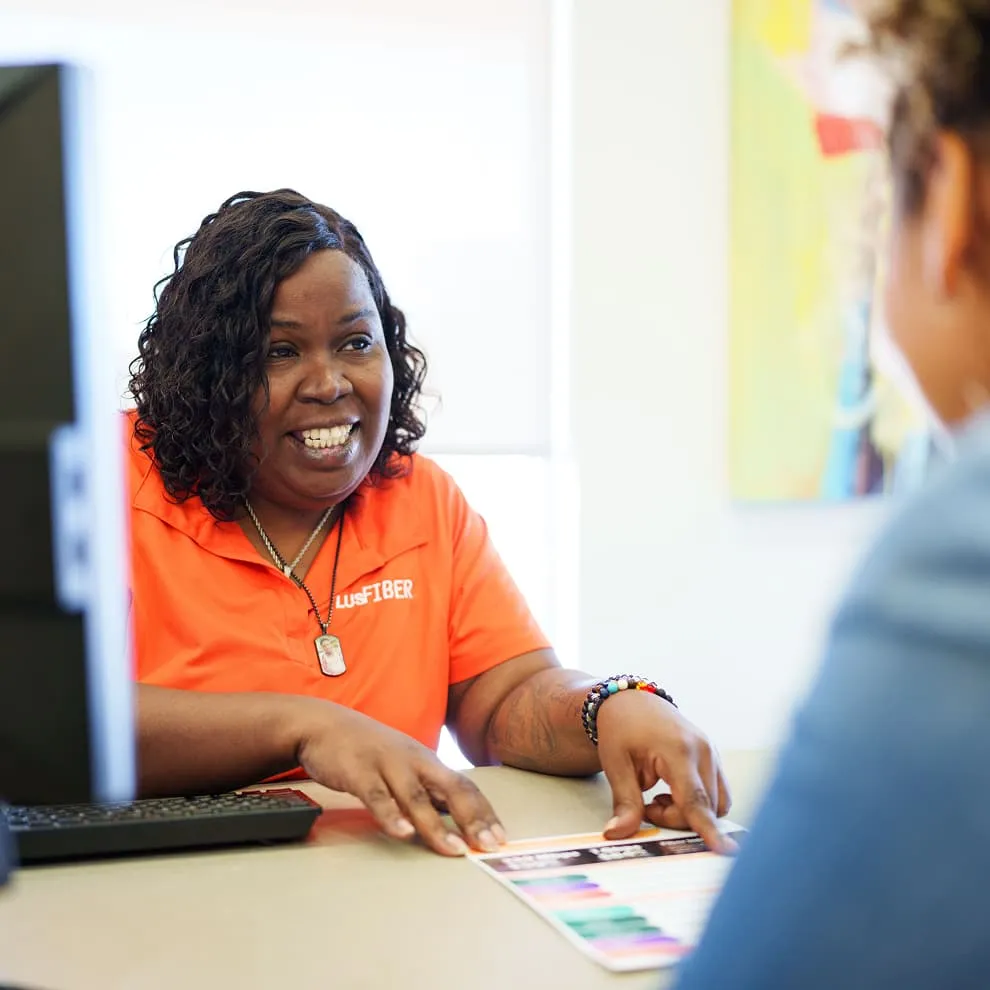 Team member Sylvia Joseph smiles while helping a customer.