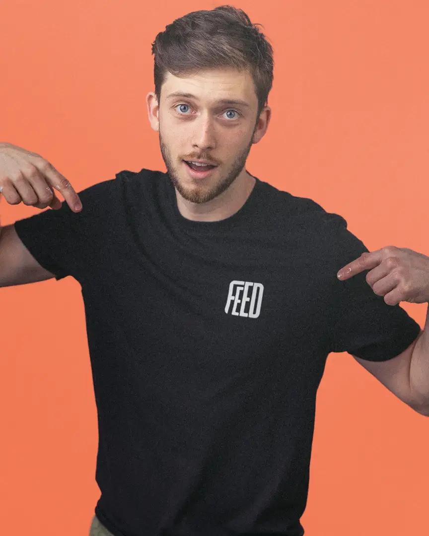 Ben pointing to the word FEED on his black t-shirt.