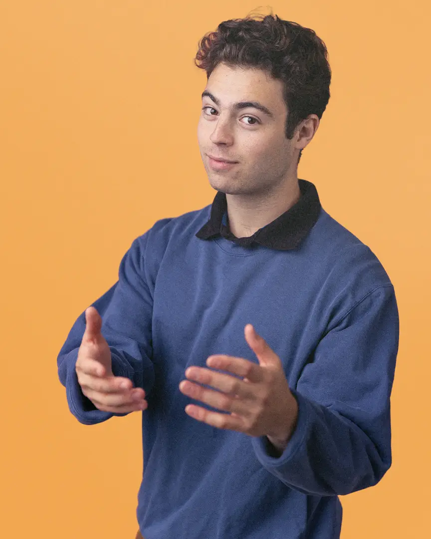 Anthony in a blue sweatshirt gesturing with his hands.