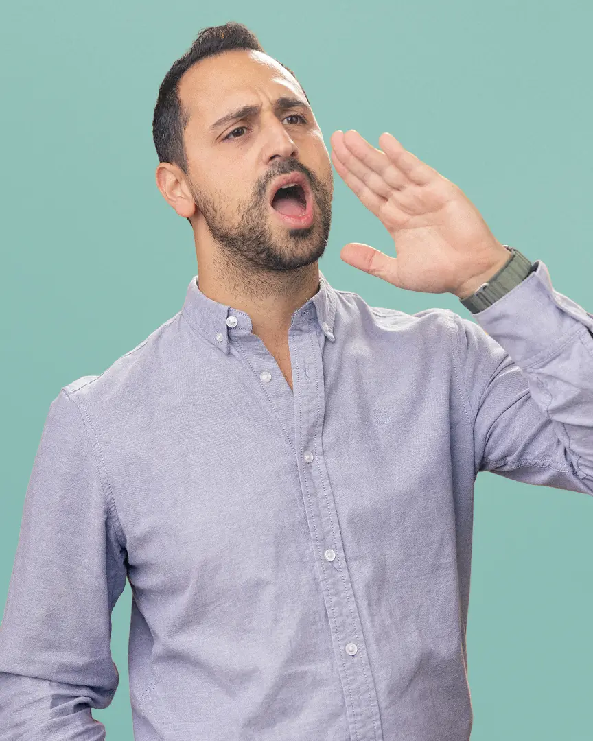 Achi shouting with hand near mouth.