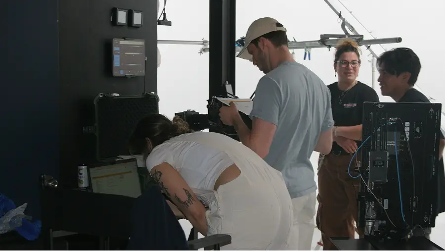 Team working together in The CAVE Studio with filming equipment, including a monitor and camera, engaged in a project.