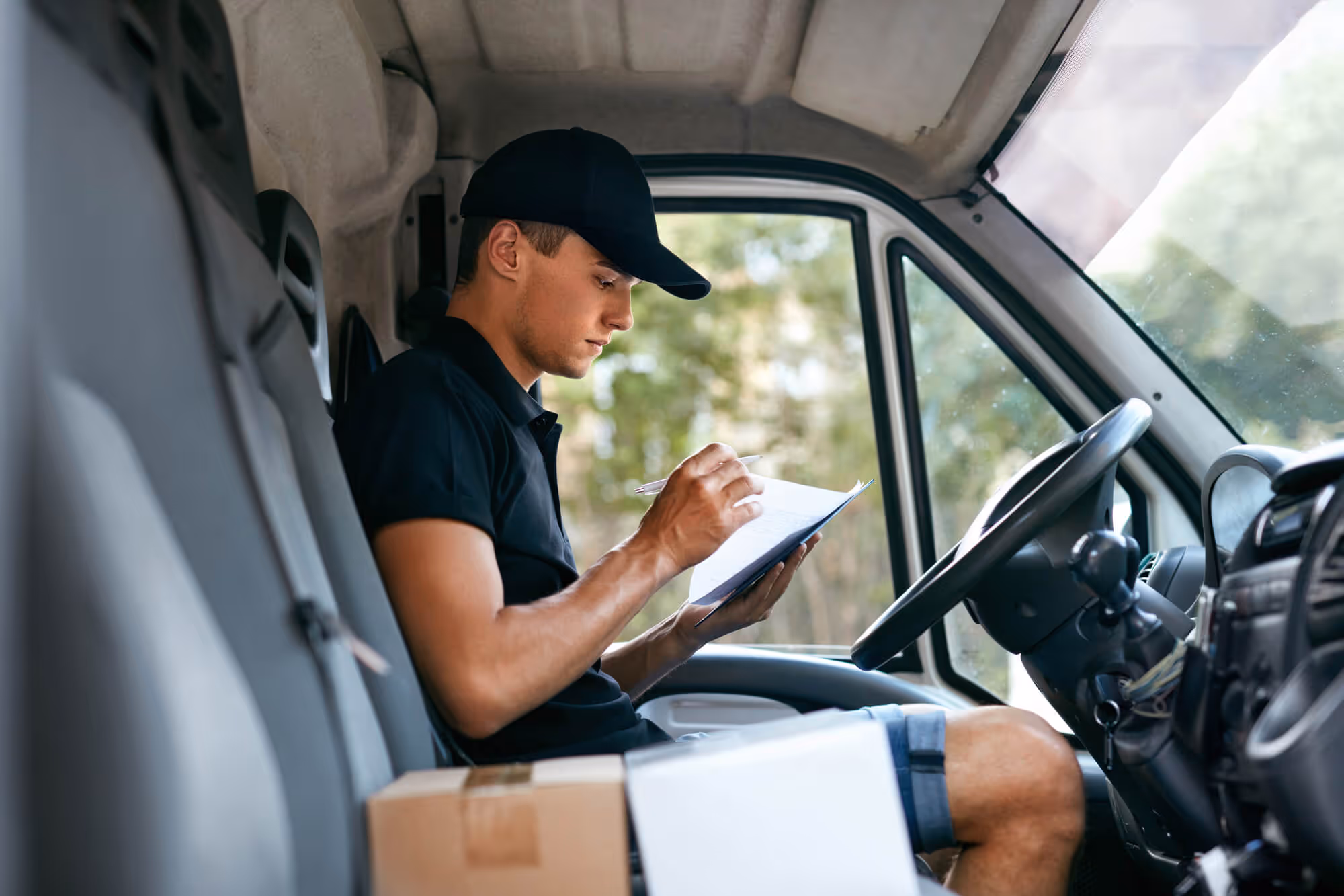 Driver driving truck but distracted by reading something