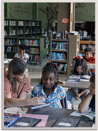 Person wearing a white glove painting a bluebird on a mural outdoors.