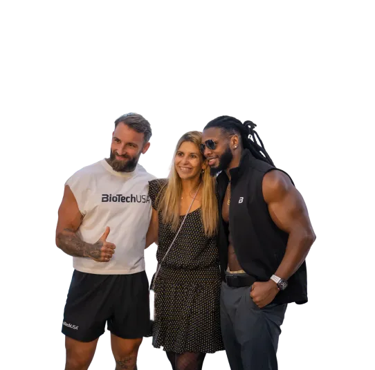 Three people posing together, including two muscular men and one woman standing between them, smiling.