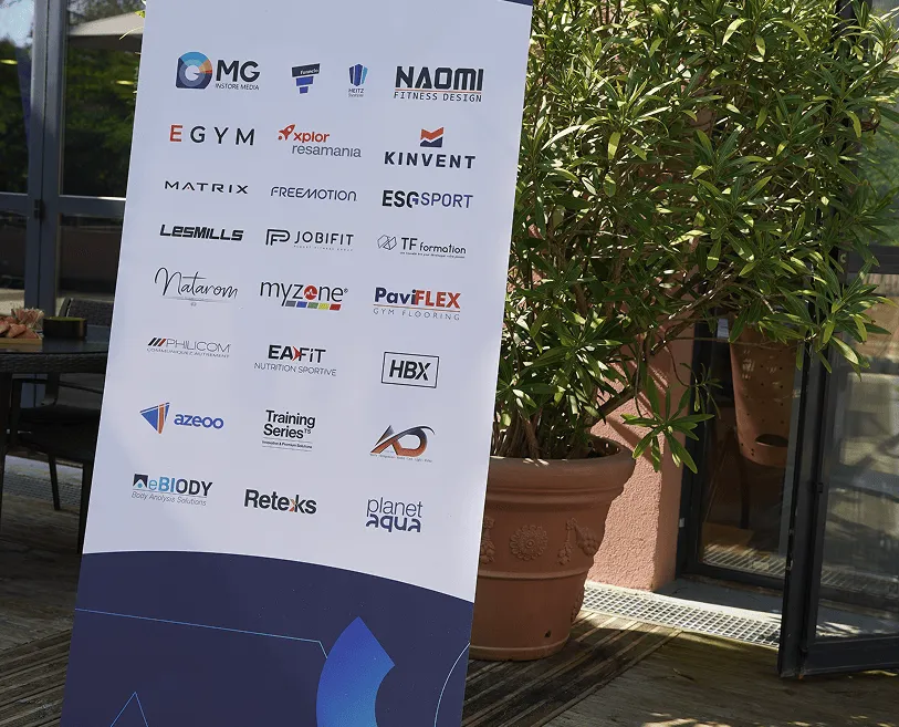 Banner displaying multiple fitness and sports brand logos including MG Instore Media, Naomi Fitness Design, EGYM, Xplor Resamania, Kinvent, Matrix, FreeMotion, ESG Sport, Les Mills, JobiFit, TF Formation, Natarom, Myzone, PaviFlex Gym Flooring, Philicom, EA Fit, HBX, Azeoo, Training Series, NeBody, Retexks, and Planet Aqua.