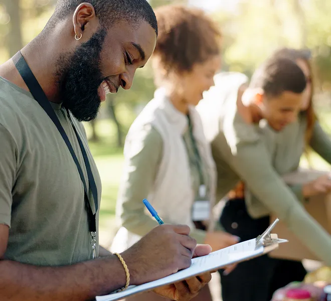 Volunteer completes form during outreach event by South Florida Horsemen’s Group.