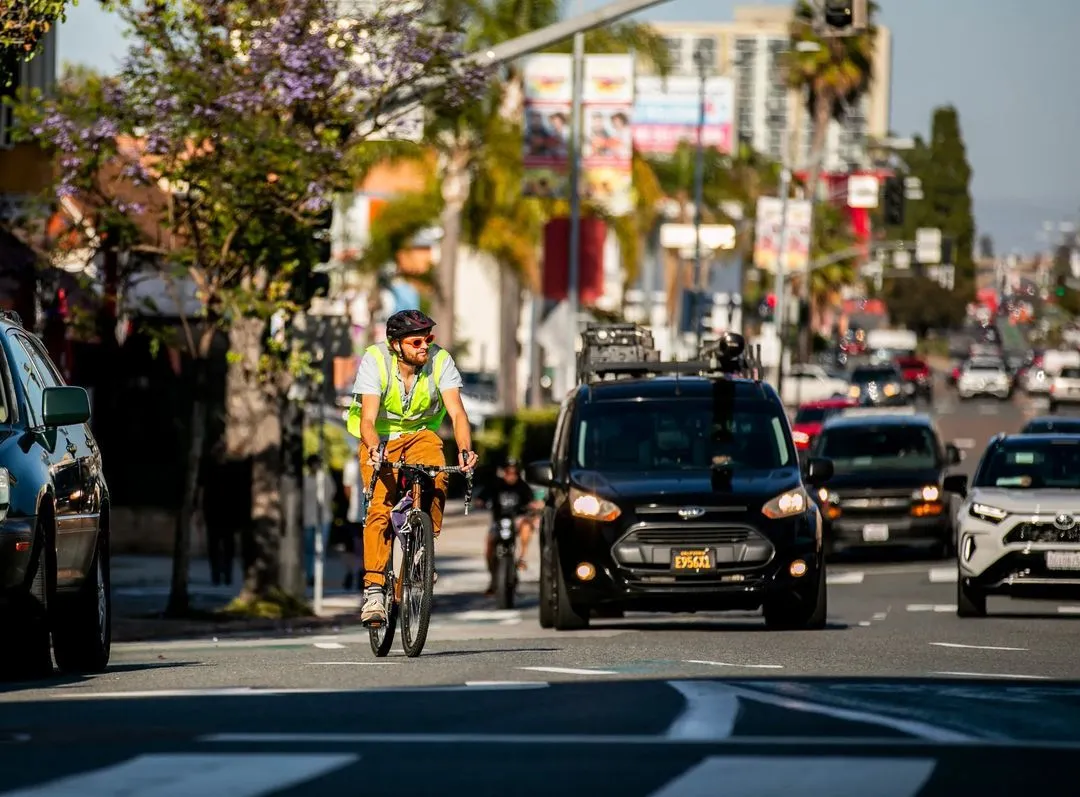 A man riding a bike on a street.