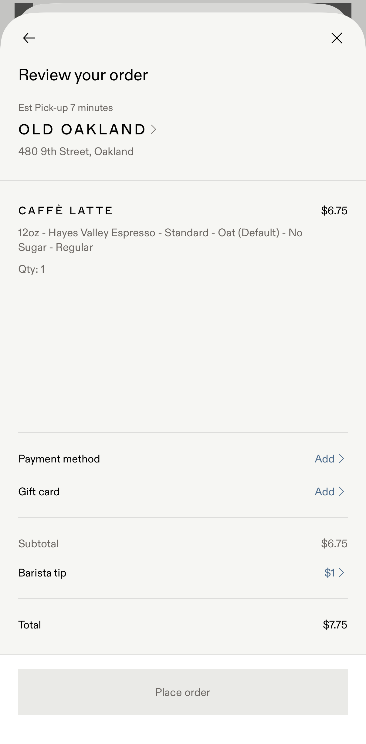 Mobile order review screen showing a 12oz caffè latte with oat milk, no sugar, priced at $6.75, from Old Oakland at 480 9th Street with estimated pick-up in 7 minutes, payment and gift card options to add, and a $1 barista tip for a total of $7.75.