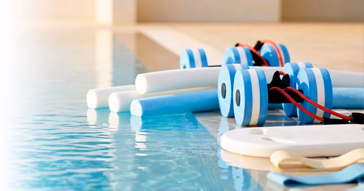Pool exercise equipment including hand buoys, noodles, and paddles placed by the poolside