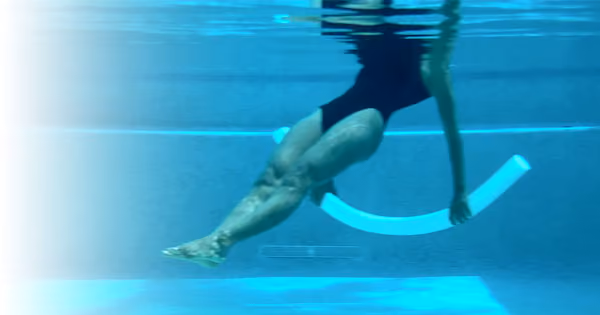 Water Pilates exercise in pool with noodle for core training